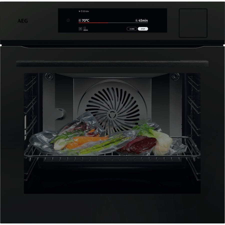AEG 9000 Series 60cm full steam and sous vide oven in matte black, front view with vacuum sealed bags on the shelf